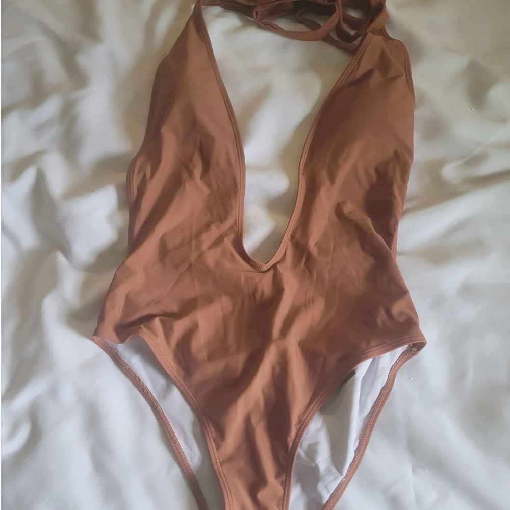 One piece swimsuit low cut back 
Brand New on